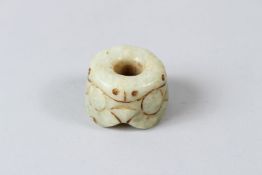 A CHINESE CARVED JADEITE PENDANT, 19TH / 20TH CENTURY. 3.5cms diameter.