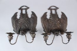 A PAIR OF BRONZE BAT SHAPED TWIN BRANCH WALL SCONCES. 24cms wide.