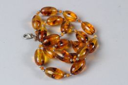 AN AMBER STYLE BEAD NECKLACE. 60cms long.