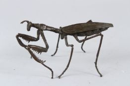 A JAPANESE STYLE BRONZE AND ARTICULATED MODEL OF A PRAYING MANTIS. 16cms long.