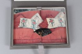 ALISON ELLIOT, An Italian miniature painting of a dog on a sofa, boxed. Painting 18cms x 13cms.