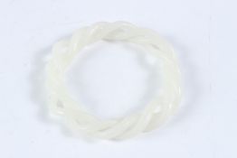 A WHITE JADE TWIST BANGLE. 9cms.