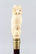 A WALKING STICK, with a carved bone handle as an owl. 90cms long.