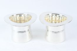 A PAIR OF POLISHED METAL TOP HAT SHAPED WINE COOLERS. 17cms high.