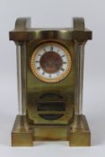 AN UNUSUAL BRASS DROP DIAL MANTLE CLOCK with enamel chapter ring and glass column supports. 36cms