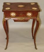 A 19TH CENTURY FRENCH KINGWOOD WORK TABLE, with oval porcelain panel and ormolu mounts, the rising