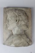 A RELIEF CAST COMPOSITE PLAQUE depicting the bust of a young man in profile. 35cms high x 27cms