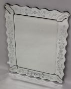 A VENETIAN STYLE RECTANGULAR WALL MIRROR with shaped frame. 74cms x 56cms.