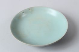 A CHINESE PALE CELADON PORCELAIN CIRCULAR SHALLOW DISH OR BRUSH WASHER, 20TH CENTURY. 18.5cms