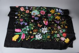 A BLACK SILK SCARF, decorated with flowers and butterflies. 87cms x 87cms.