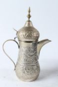 A KUWAITI ARABIC COFFEE DALLAH in a velvet box. Dallah 29cms high.