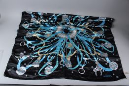 A HERMES, PARIS SILK SCARF, black ground with horse bits, ropes and tassels. 90cms x 90cms.