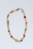 AN 18CT YELLOW GOLD, MULTI-COLOURED SAPPHIRE AND DIAMOND LINE BRACELET.