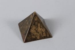 A SMALL ENGRAVED BRASS EGYPTIAN REVIVAL PYRAMID SHAPED PAPERWEIGHT. 4.5cms high.