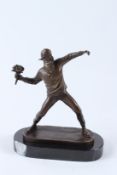 AFTER BANKSY. A bronze figure of a man throwing a bunch of flowers, on an oval marble base. 25cms