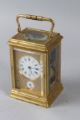 A 19TH CENTURY FRENCH BRASS CARRIAGE CLOCK, with alarm and repeat mechanism, chased gilt brass case.