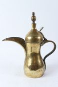 A LARGE BRASS ARABIC COFFEE DALLAH. 40cms high.