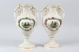 A PAIR OF CONTINENTAL PORCELAIN TWIN HANDLED VASES, with scrolling handles, flowerhead encrusted