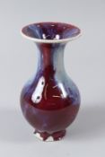 A CHINESE FLAMBE BOTTLE VASE, 19TH CENTURY (old foot rim damage). 17cms high.