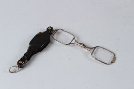 A SMALL PAIR OF TORTOISESHELL LORGNETTES. 8cms long.