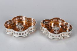 A PAIR OF PLATED FAUX TORTOISESHELL COASTERS. 15.5cms wide.