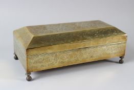 AN ISLAMIC BRASS RECTANGULAR BOX, 20TH CENTURY, with stylised scrolling engraved decoration, on four