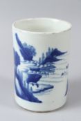 A CHINESE BLUE AND WHITE PORCELAIN BRUSH POT, painted with a mountainous landscape. 16cms high.