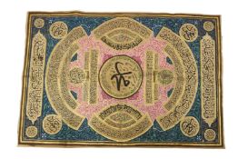 A 20TH CENTURY OTTOMAN TEXTILE, painted with panels of calligraphy. 87cms x 60cms.
