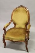A VICTORIAN ROSEWOOD OPEN ARMCHAIR, with upholstered back and seat, carved frame on cabriole legs.