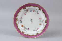 A MEISSEN PORCELAIN PLATE, pink and gilt border, the centre painted with sprays of flowers. 23cms