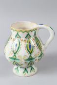 AN OTTOMAN TURKISH KUTAHYA WINE CUP, with blue, yellow and green stylised decoration. 15cms high.