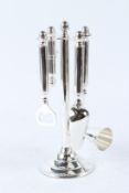 A SET OF PLATED BAR TOOLS ON A STAND. 28cms high.