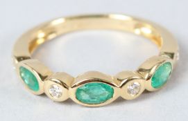 AN 18CT YELLOW GOLD, EMERALD AND DIAMOND SEVEN STONE RING.