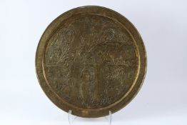 A PERSIAN EMBOSSED TRAY WITH THE STORY OF ADAM AND EVE. 60cms diameter.