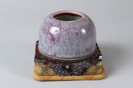 A CHINESE LATE 19TH CENTURY FLAMBE WATER POT with stand. 11cms high.