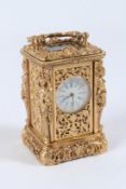 A MINIATURE GILT BRONZE CARRIAGE CLOCK with female figure supports. 6.5cms high.