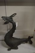 Cast metal dragon, possibly a lamp or fountain.
