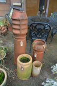 Three terracotta chimney pots and another item.