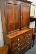 A George III mahogany cupboard on chest.