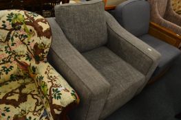 A modern grey upholstered armchair.