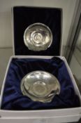 A pair of coin dishes.