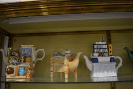 A collection of novelty teapots.