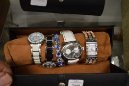 A collection of decorative wristwatches in leather cases.