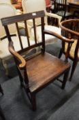A 19th century country made carver chair with solid seat.