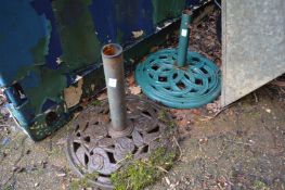 Two metal parasol bases.