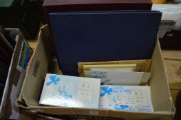 Stamp albums and loose stamps.