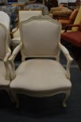 A French style cream painted and upholstered open armchair.