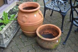 Two large terracotta planters.
