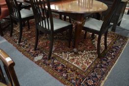 A Persian rug with geometric design (moth damage) 284cm x 192cm.