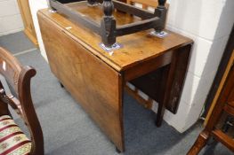 A 19th century oak drop-leaf gateleg dining table.